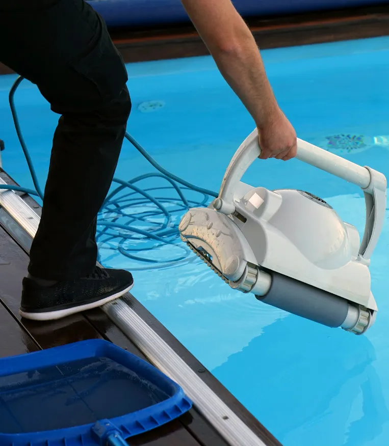 Pool Cleaning Services - Professional pool cleaner maintaining a backyard pool